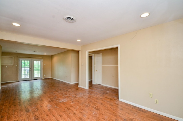 5914 Newquay St, Houston, TX 77085 - empty room with baseboards, wood finished floors, recessed lighting, and french doors
