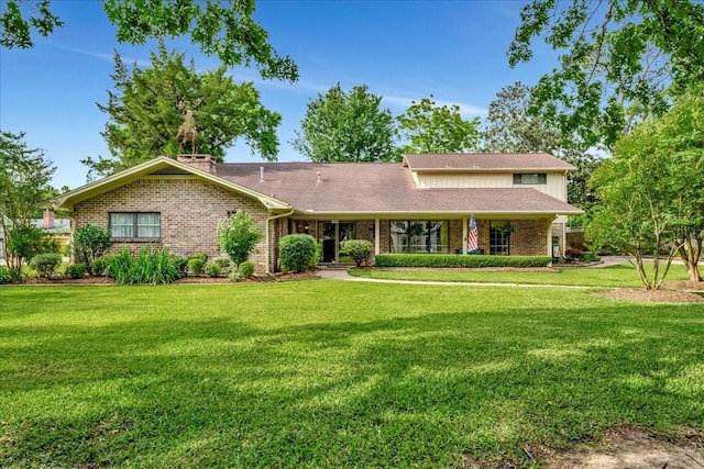 1705 E Texas Ave, Baytown, TX 77520 - view of front of property with a front yard and brick siding
