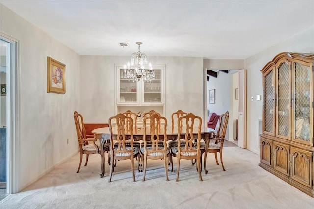 1705 E Texas Ave, Baytown, TX 77520 - dining room featuring light carpet, a chandelier, and baseboards