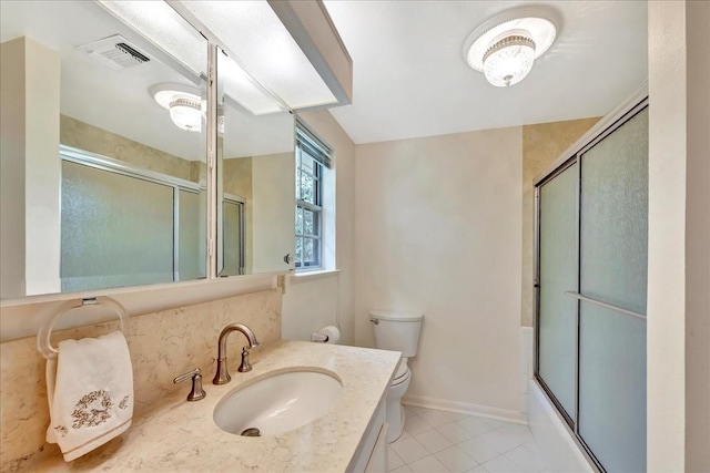 1705 E Texas Ave, Baytown, TX 77520 - bathroom with toilet, tile patterned floors, vanity, enclosed tub / shower combo, and baseboards