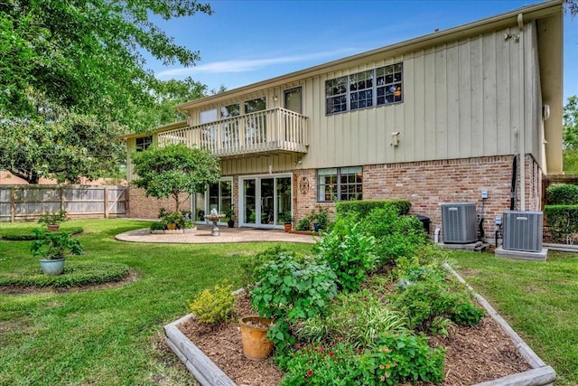 1705 E Texas Ave, Baytown, TX 77520 - rear view of house featuring brick siding, a balcony, central air condition unit, and a patio area
