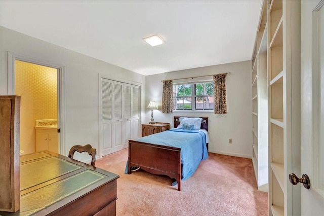 1705 E Texas Ave, Baytown, TX 77520 - bedroom featuring light colored carpet, a closet, and baseboards