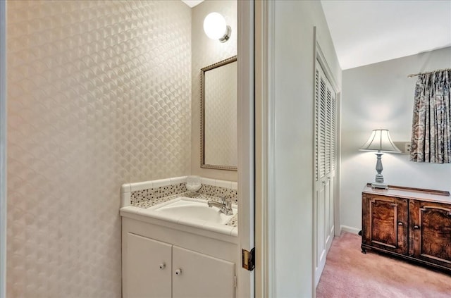 1705 E Texas Ave, Baytown, TX 77520 - bathroom featuring vanity, baseboards, and wallpapered walls