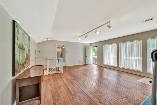 1705 E Texas Ave, Baytown, TX 77520 - unfurnished room with light wood-type flooring, lofted ceiling, baseboards, and track lighting