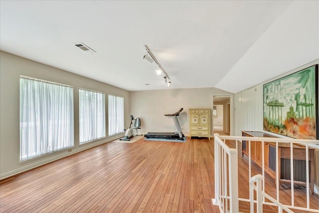 1705 E Texas Ave, Baytown, TX 77520 - workout room featuring light wood-style flooring and rail lighting