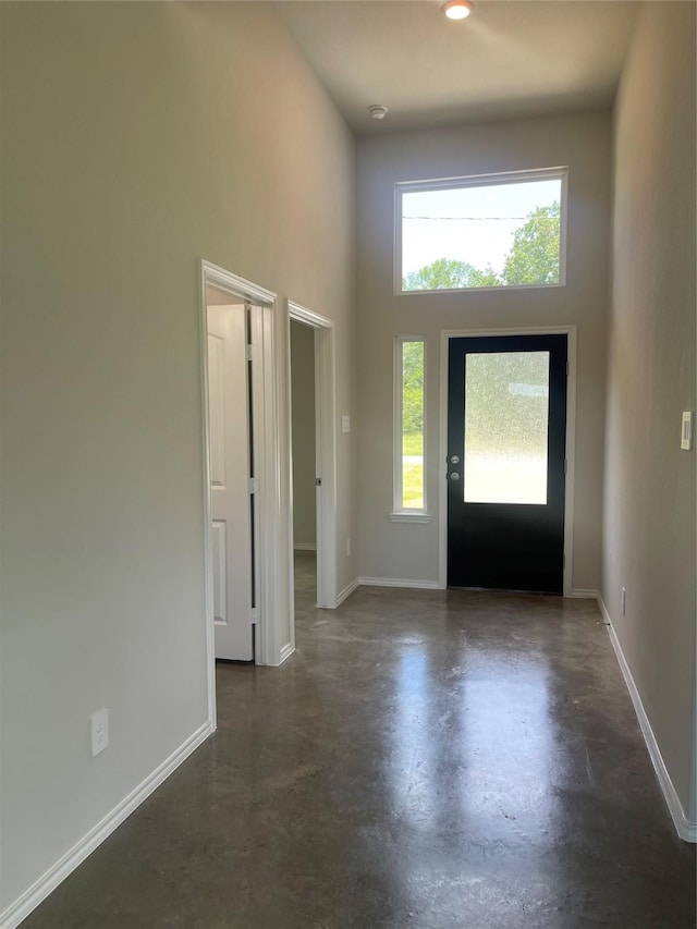 8 Greenway Dr, Trinity, TX 75862 - entryway with concrete flooring, a high ceiling, and baseboards