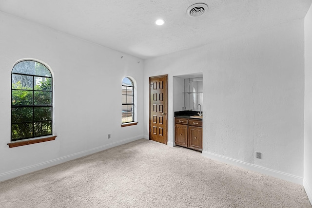 1915 Morton League Rd, Richmond, TX 77406 - unfurnished bedroom with light carpet, baseboards, a sink, and recessed lighting