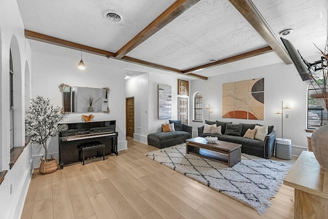 1915 Morton League Rd, Richmond, TX 77406 - living area with beam ceiling, wood finished floors, arched walkways, and baseboards