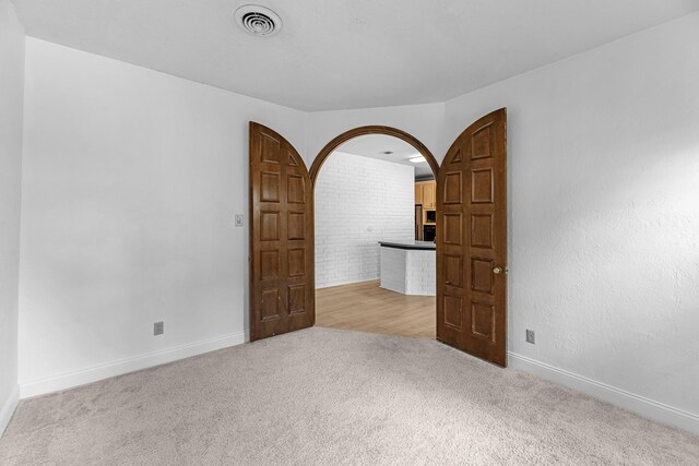 1915 Morton League Rd, Richmond, TX 77406 - unfurnished room featuring light colored carpet, arched walkways, and baseboards