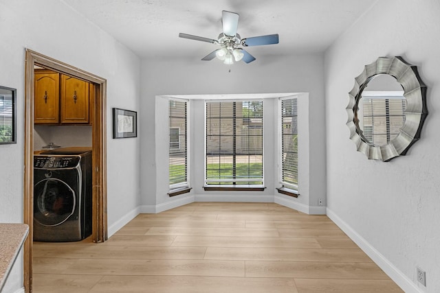 1915 Morton League Rd, Richmond, TX 77406 - unfurnished dining area featuring washer / clothes dryer, light wood finished floors, a ceiling fan, and baseboards