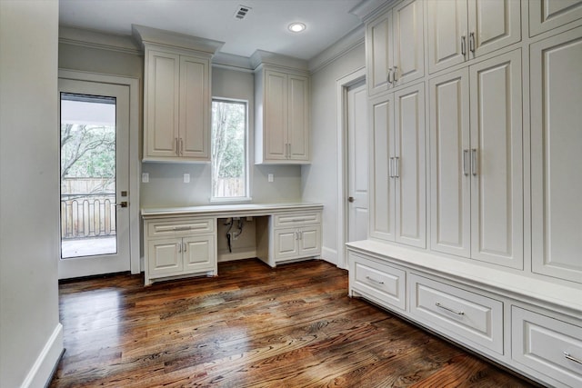 8304 Maple Ct, Bellaire, TX 77401 - unfurnished office with built in desk, plenty of natural light, dark wood finished floors, and recessed lighting