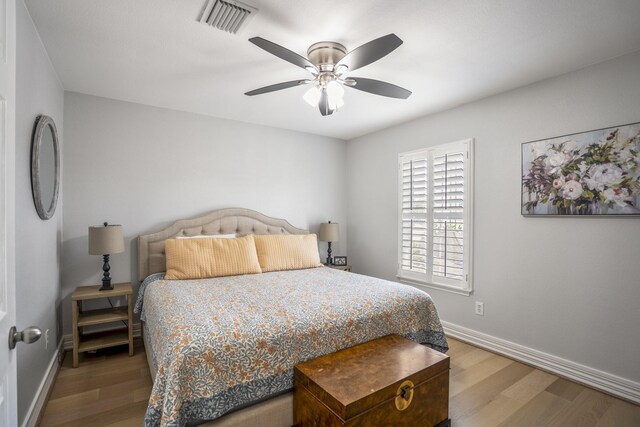 1441 W 25th St Unit D, Houston, TX 77008 - bedroom featuring wood finished floors, baseboards, and a ceiling fan