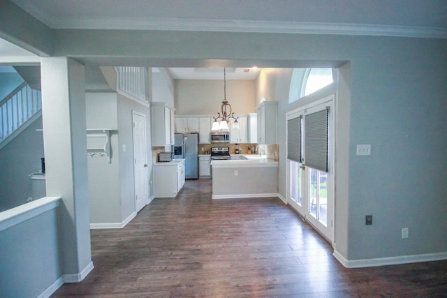 10407 Redwood Dr, Baytown, TX 77523 - kitchen featuring appliances with stainless steel finishes, dark wood-style floors, a chandelier, open floor plan, and white cabinetry
