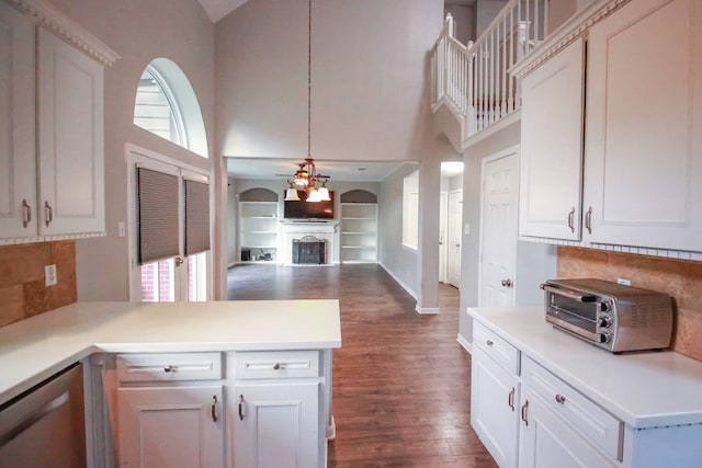10407 Redwood Dr, Baytown, TX 77523 - kitchen with a ceiling fan, dark wood finished floors, a towering ceiling, healthy amount of natural light, and a fireplace