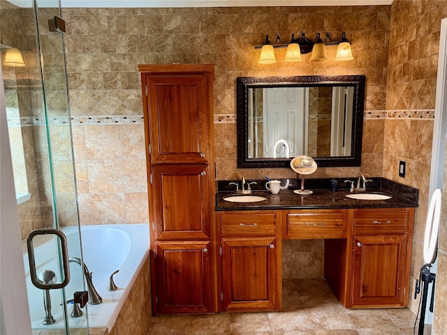 10407 Redwood Dr, Baytown, TX 77523 - bathroom featuring tile walls, a garden tub, a shower stall, and double vanity