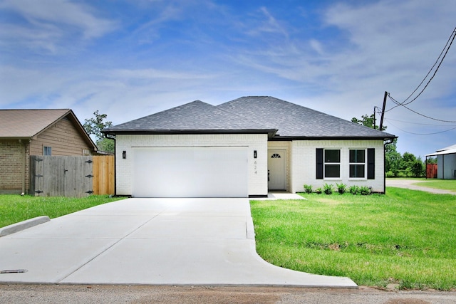 624 Pinewood Dr, Conroe, TX 77385 - view of front of house featuring brick siding, driveway, an attached garage, and a shingled roof