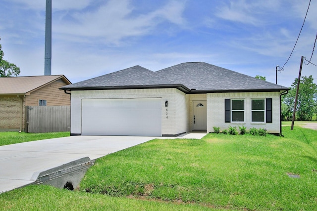 624 Pinewood Dr, Conroe, TX 77385 - view of front of home featuring roof with shingles, an attached garage, driveway, and brick siding