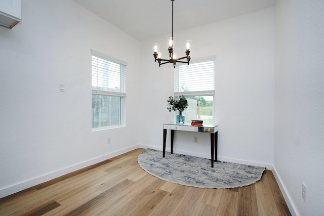 624 Pinewood Dr, Conroe, TX 77385 - dining area with wood finished floors, a chandelier, and baseboards