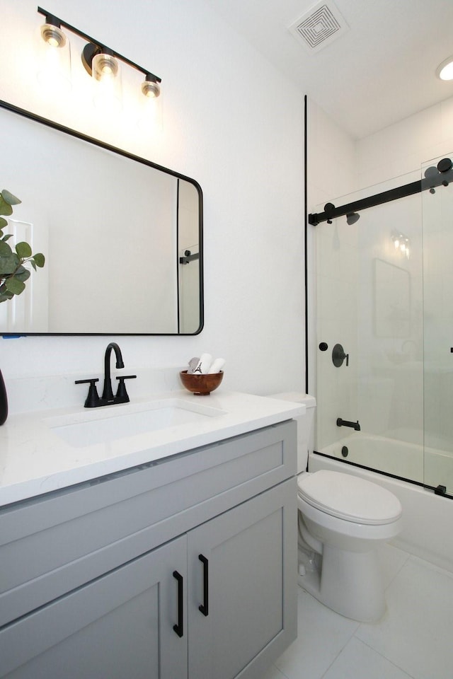 624 Pinewood Dr, Conroe, TX 77385 - bathroom featuring vanity, toilet, bath / shower combo with glass door, and tile patterned floors
