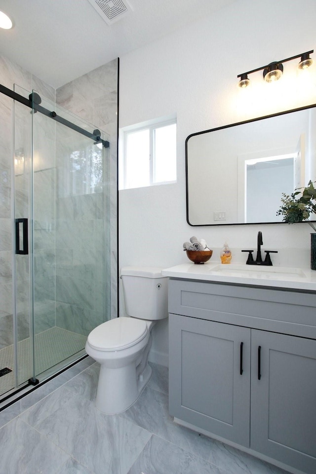 624 Pinewood Dr, Conroe, TX 77385 - bathroom featuring toilet, vanity, a shower stall, and marble look tile flooring