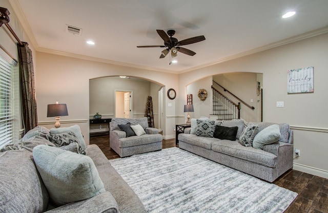 9107 Black Buck Ln, Conroe, TX 77303 - living area featuring arched walkways, ceiling fan, baseboards, dark wood-style floors, and stairway
