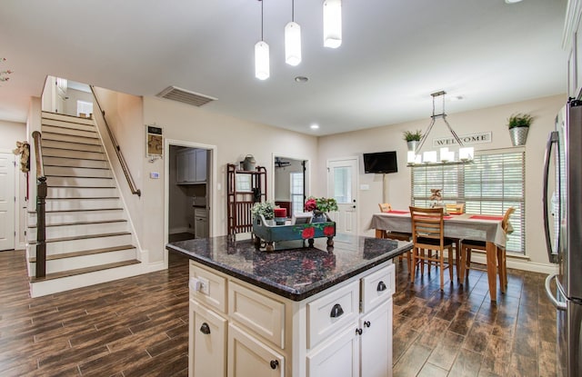 9107 Black Buck Ln, Conroe, TX 77303 - kitchen featuring dark wood finished floors, freestanding refrigerator, plenty of natural light, and a center island