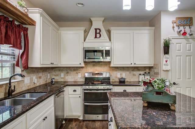 9107 Black Buck Ln, Conroe, TX 77303 - kitchen with stainless steel appliances, a sink, white cabinetry, and dark wood-type flooring