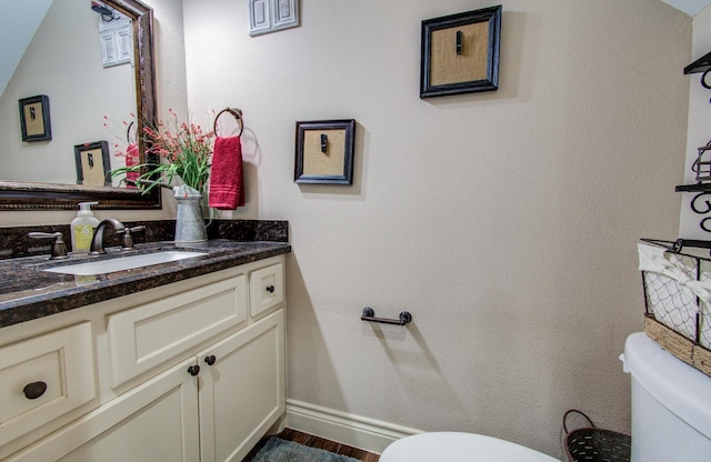 9107 Black Buck Ln, Conroe, TX 77303 - bathroom featuring toilet, vanity, wood finished floors, and baseboards