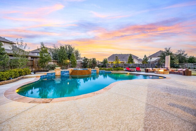 2803 Chester Knoll Ct, Katy, TX 77494 - pool at dusk featuring a patio, a fenced backyard, and a pool with connected hot tub