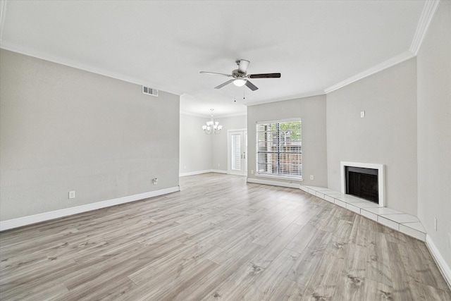 9707 Richmond Ave Unit 3, Houston, TX 77042 - unfurnished living room with a chandelier, crown molding, a ceiling fan, a tile fireplace, and light wood-type flooring