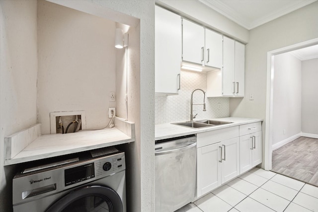 9707 Richmond Ave Unit 3, Houston, TX 77042 - kitchen featuring stainless steel dishwasher, washer / dryer, a sink, ornamental molding, and backsplash