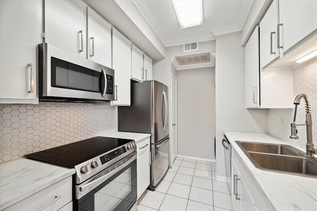 9707 Richmond Ave Unit 3, Houston, TX 77042 - kitchen with appliances with stainless steel finishes, a sink, backsplash, white cabinetry, and ornamental molding
