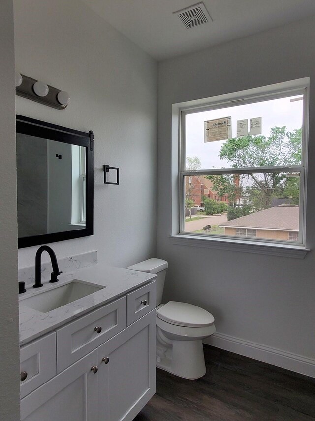 2615 Campbell St, Houston, TX 77026 - bathroom featuring vanity, wood finished floors, and toilet