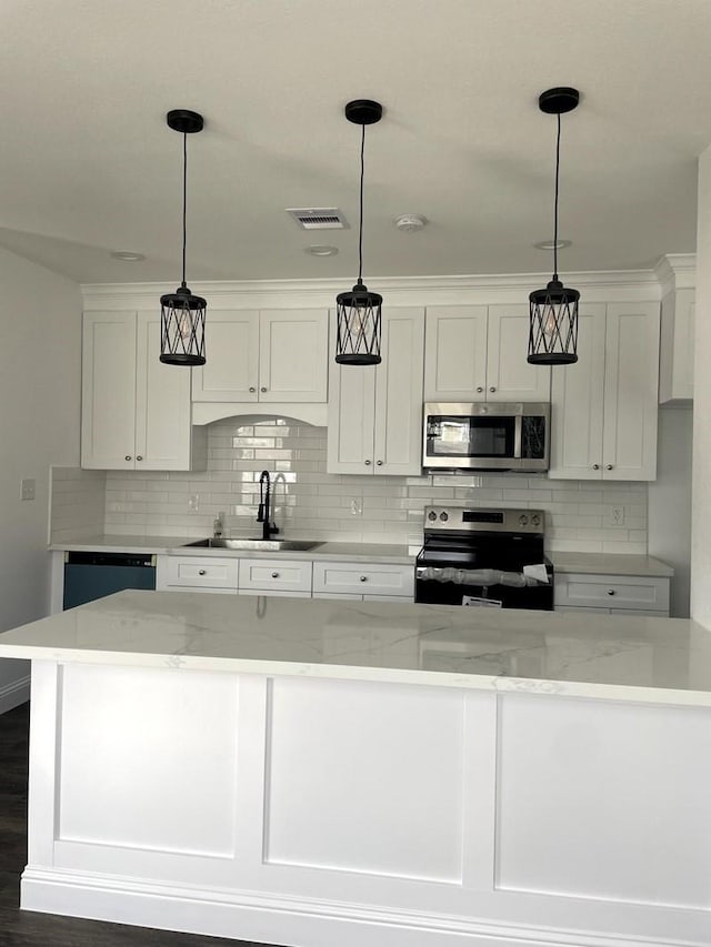 2615 Campbell St, Houston, TX 77026 - kitchen featuring electric range, stainless steel microwave, a sink, and tasteful backsplash