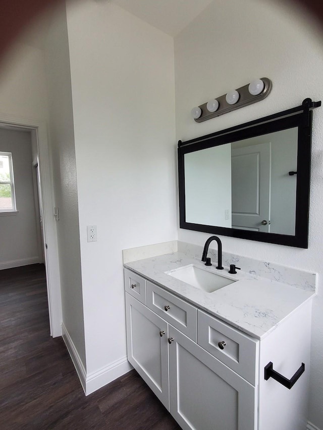 2615 Campbell St, Houston, TX 77026 - bathroom with wood finished floors, vanity, and baseboards