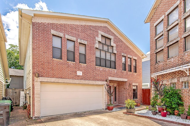 5229 Larkin St, Houston, TX 77007 - view of front of house featuring a garage, brick siding, and concrete driveway