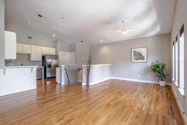 5229 Larkin St, Houston, TX 77007 - unfurnished living room featuring light wood-style flooring, ceiling fan, baseboards, lofted ceiling, and recessed lighting