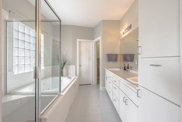 5229 Larkin St, Houston, TX 77007 - bathroom with a jetted tub, double vanity, a stall shower, and tile patterned floors
