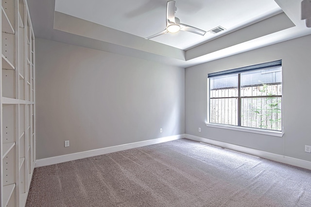 5229 Larkin St, Houston, TX 77007 - spare room with carpet floors, a tray ceiling, a ceiling fan, and baseboards