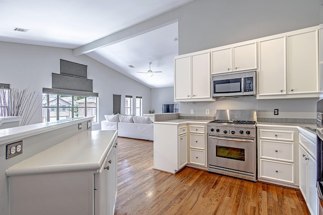 5229 Larkin St, Houston, TX 77007 - kitchen with stainless steel appliances, open floor plan, light wood-type flooring, and a ceiling fan