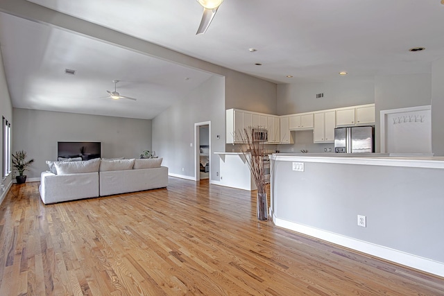 5229 Larkin St, Houston, TX 77007 - living area featuring a ceiling fan, high vaulted ceiling, light wood-style flooring, baseboards, and recessed lighting