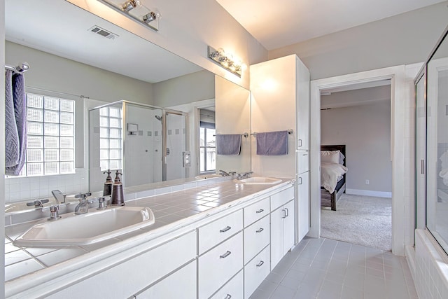 5229 Larkin St, Houston, TX 77007 - ensuite bathroom featuring a stall shower, tile patterned floors, double vanity, and a tub to relax in