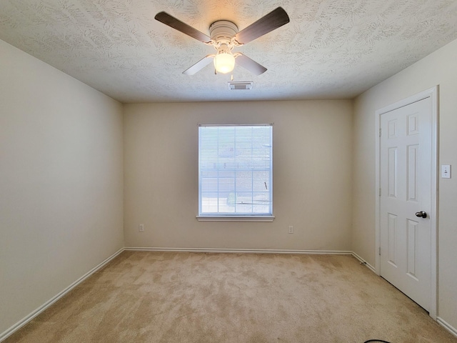 6135 Shelbourne Park Ln, Houston, TX 77084 - spare room featuring light carpet, baseboards, a ceiling fan, and a textured ceiling