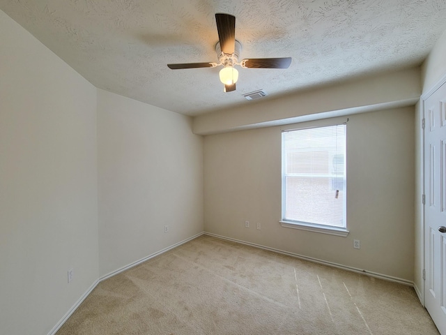 6135 Shelbourne Park Ln, Houston, TX 77084 - empty room featuring light colored carpet, a ceiling fan, a textured ceiling, and baseboards