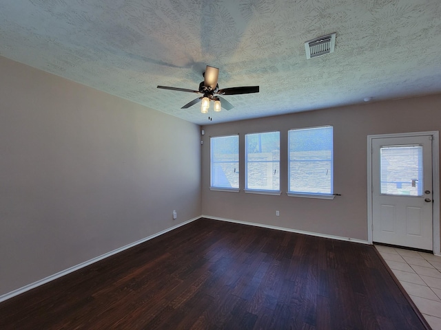 6135 Shelbourne Park Ln, Houston, TX 77084 - empty room with wood finished floors, a ceiling fan, a textured ceiling, and baseboards