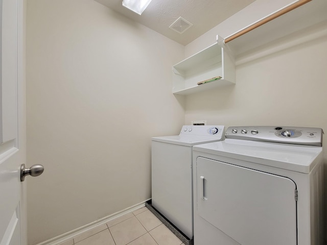 6135 Shelbourne Park Ln, Houston, TX 77084 - washroom with washer and clothes dryer, light tile patterned floors, and baseboards