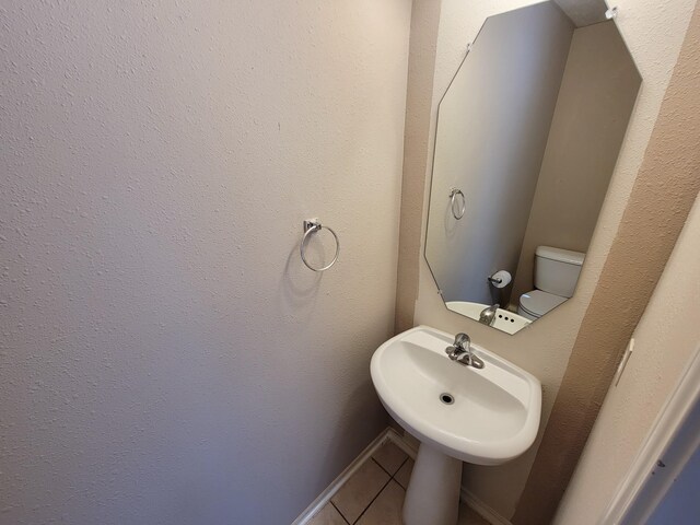 6135 Shelbourne Park Ln, Houston, TX 77084 - bathroom with tile patterned flooring, toilet, and a sink