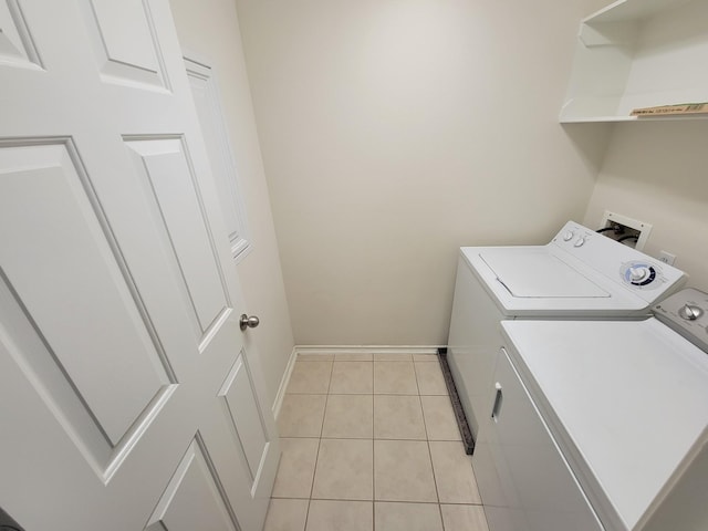 6135 Shelbourne Park Ln, Houston, TX 77084 - laundry area with separate washer and dryer, light tile patterned floors, and baseboards