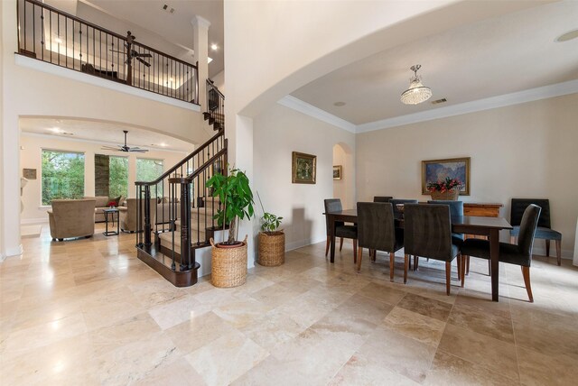 1227 Eversham Way, Kingwood, TX 77339 - entrance foyer featuring arched walkways, a ceiling fan, stairs, crown molding, and baseboards