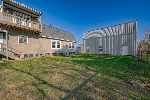 206 S Idaho St, La Porte, TX 77571 - rear view of property featuring a lawn, a pole building, an outbuilding, a balcony, and cooling unit